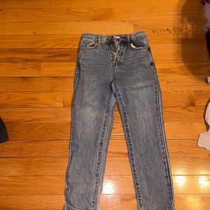 Pascun thrifted jeans that are blue and are straight legged with buttons